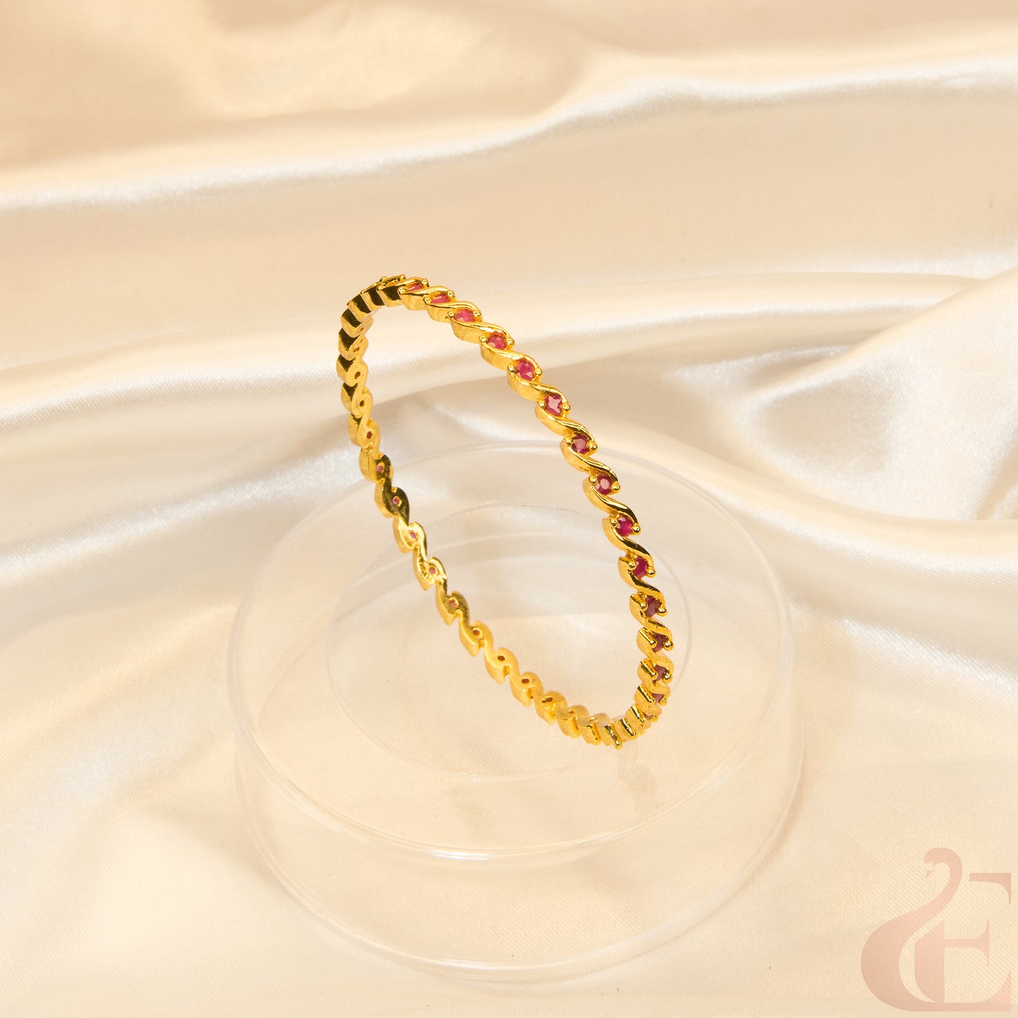 Ad bangle in gold finish with ruby stone top view