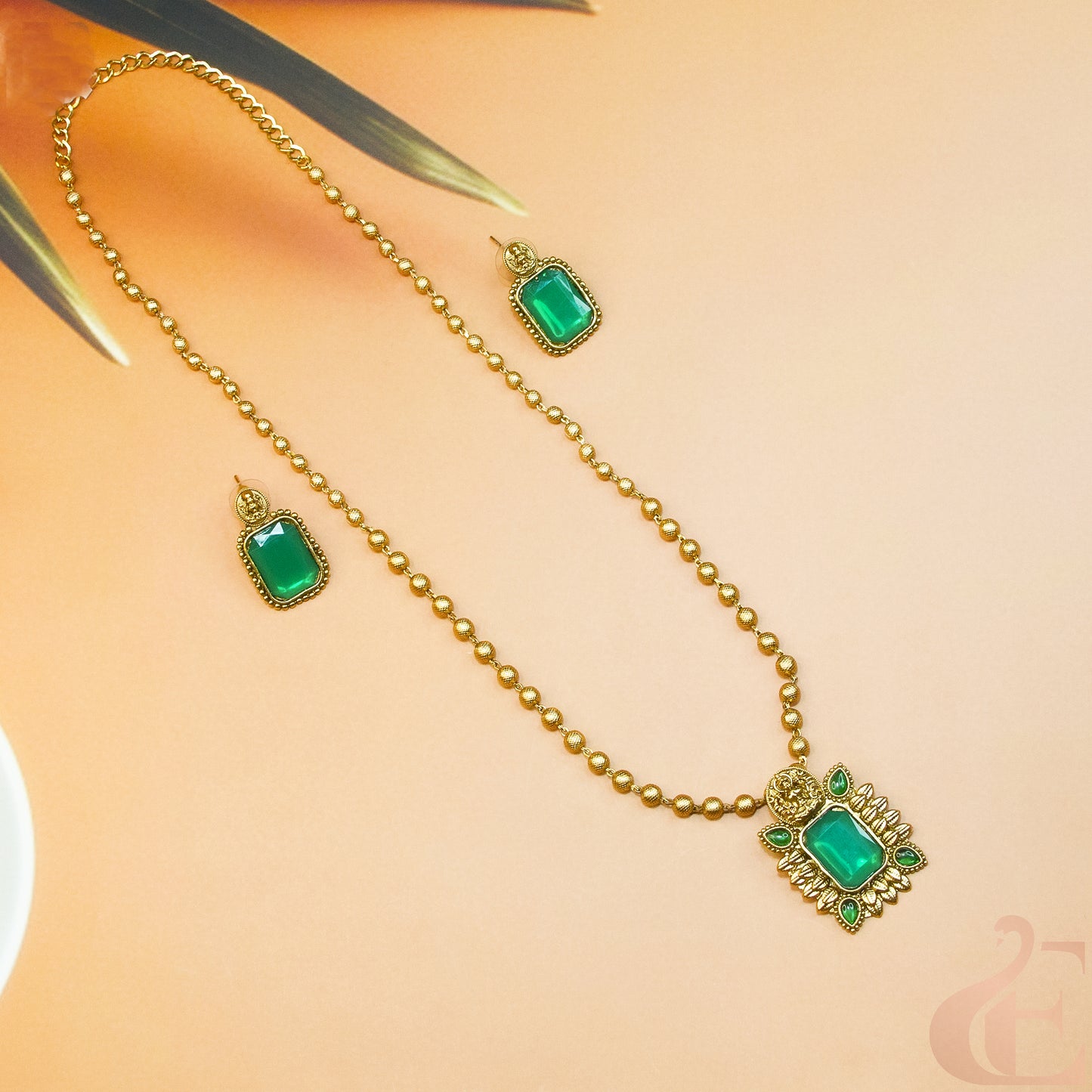 Side view of Antique Temple Long Necklace & Earrings Green stones