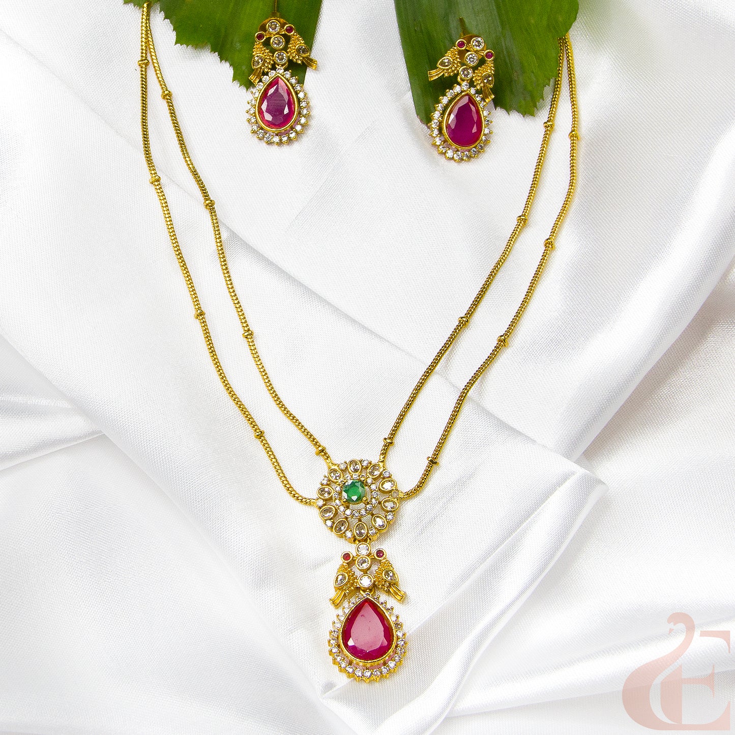 Top view of Premium AD stone Pendant Chain Neckpiece & Earrings , ruby green stones