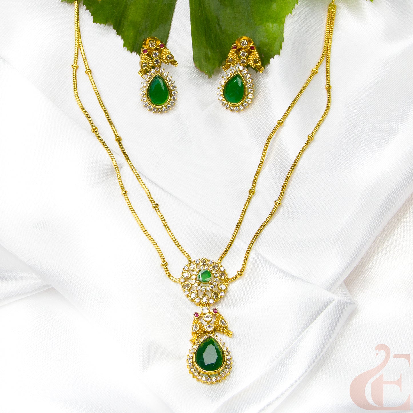 Top view of Premium AD stone Pendant Chain Neckpiece & Earrings , green stones
