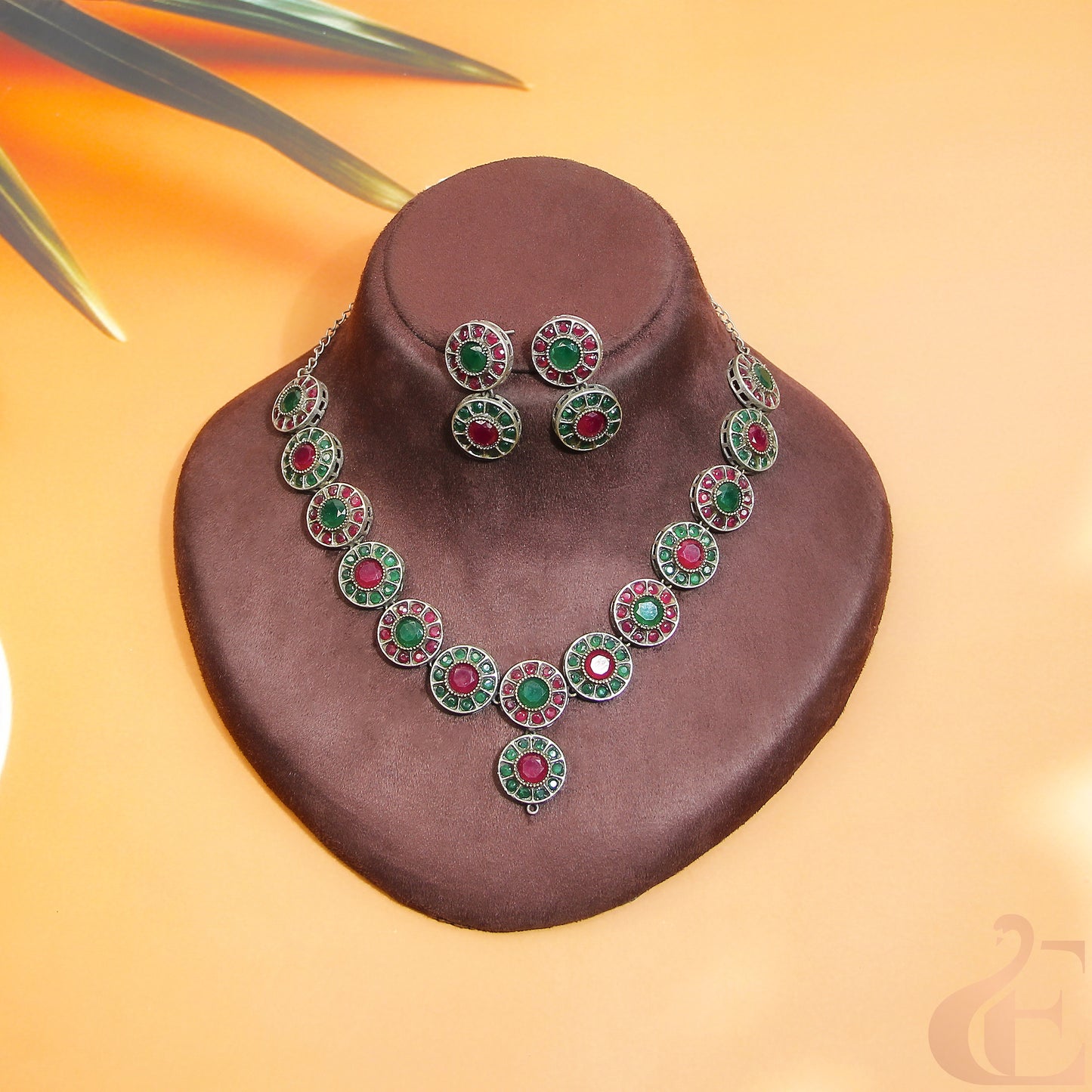 Top view of Silver Replica AD Stone Necklace & Earrings green ruby stones