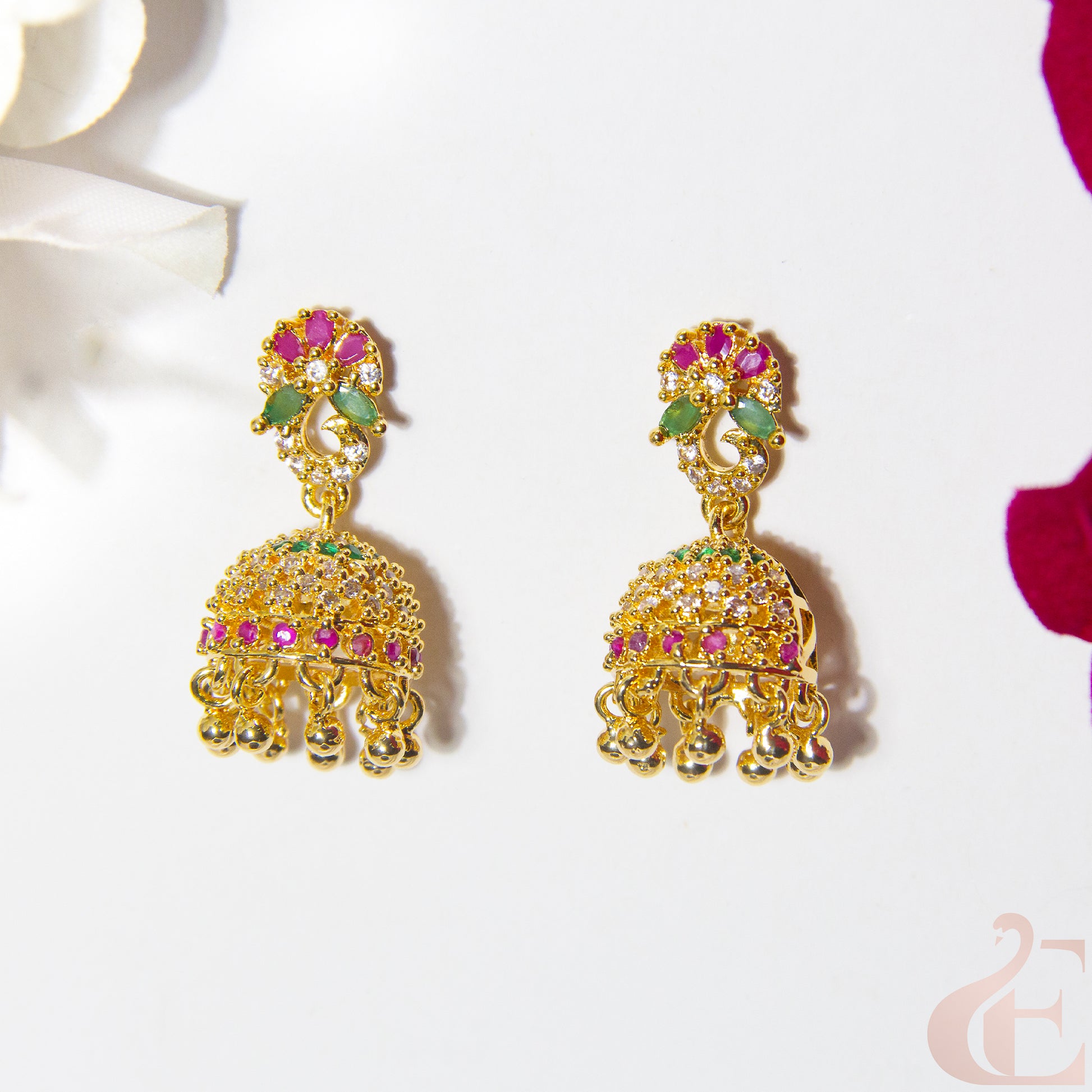 Gold AD earrings with colorful gemstones Ruby green on a white background