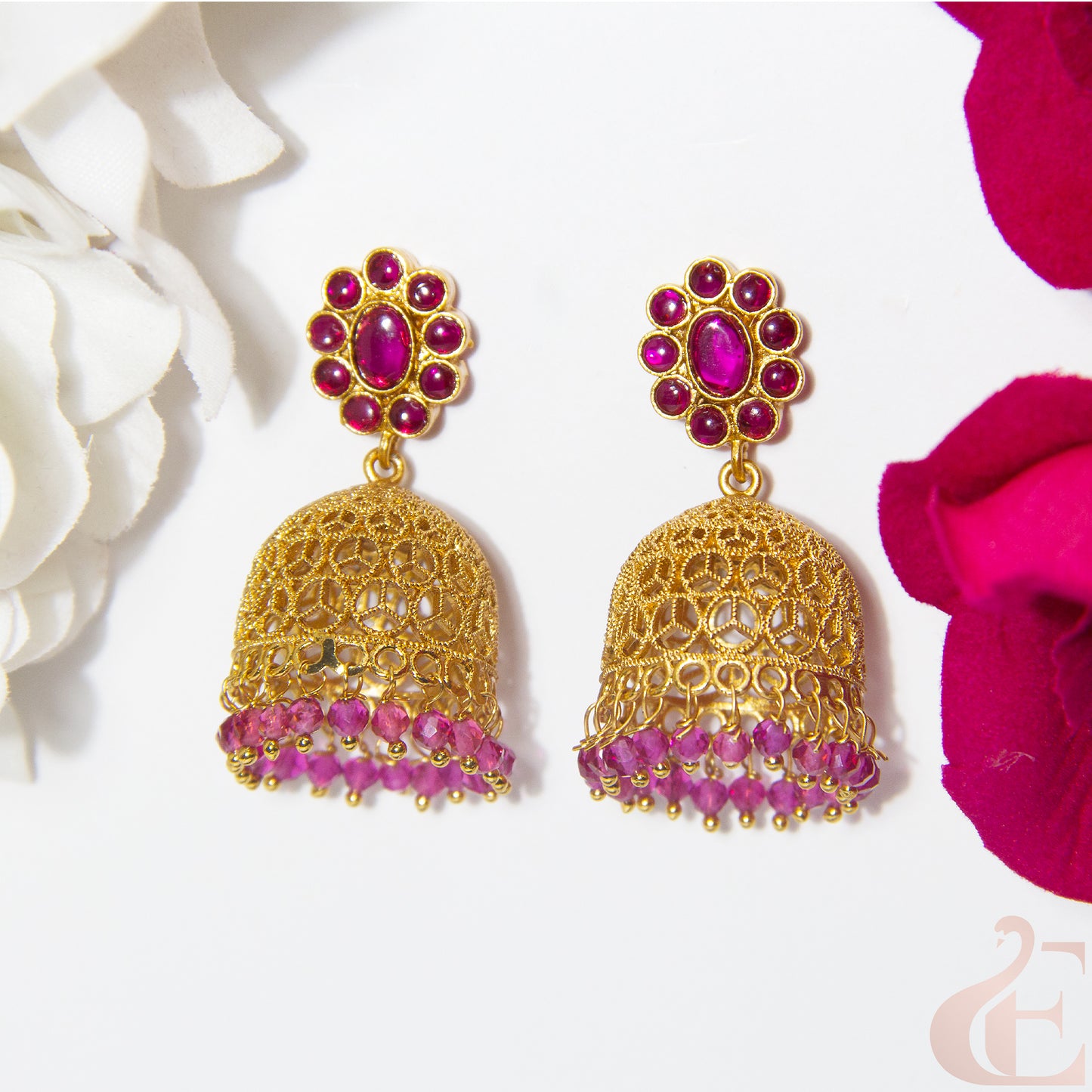 Gold and Ruby earrings with floral background