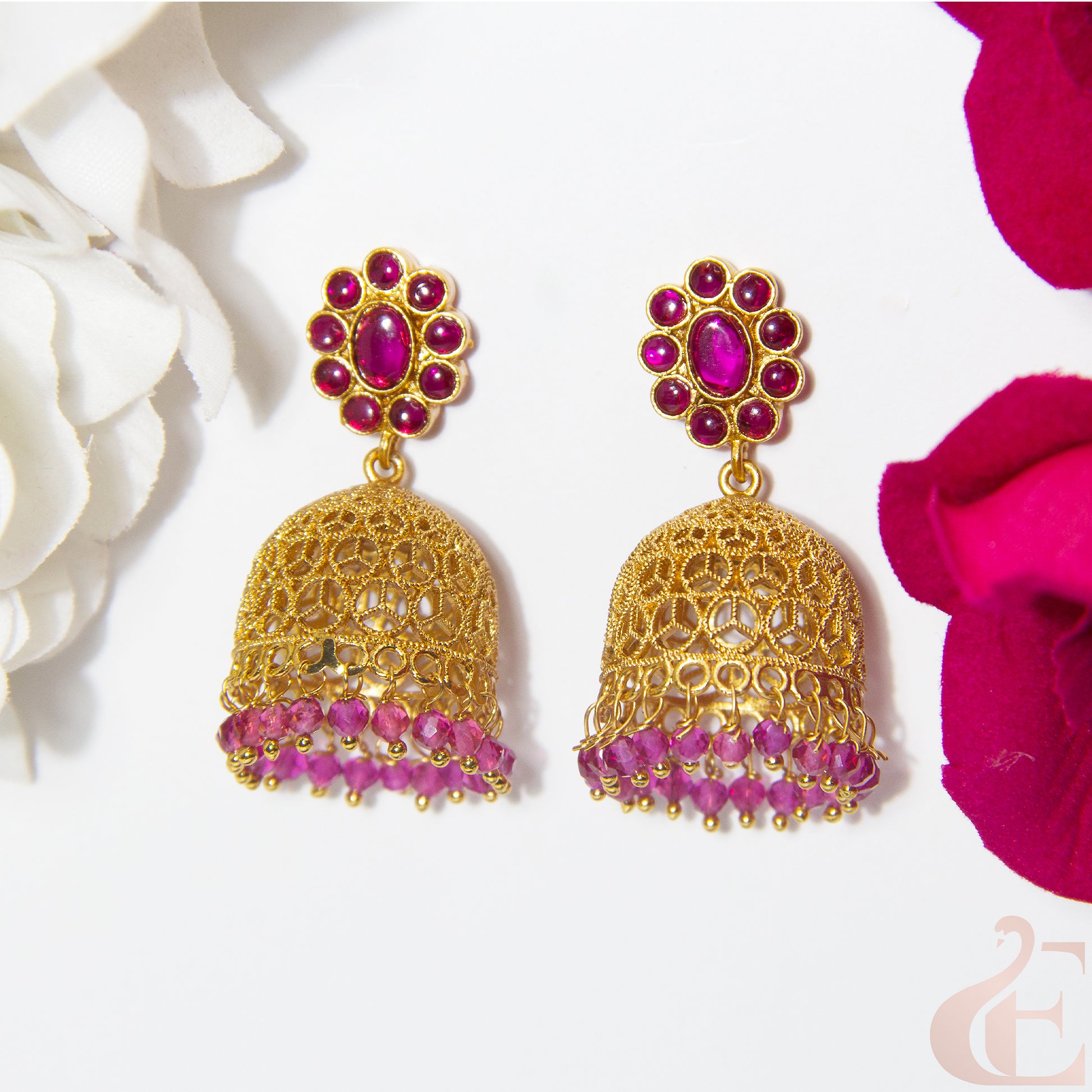 Gold and Ruby earrings with floral background