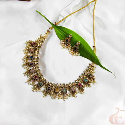 Ornate necklace with colorful stones on a white fabric background