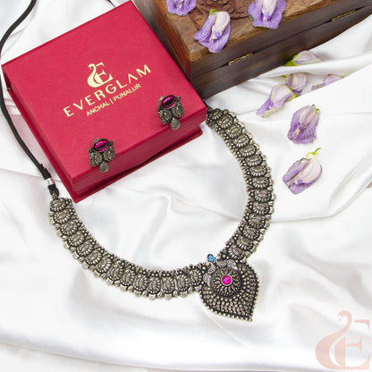 Top view of German Silver Replica Choker & Earrings ruby blue stones 