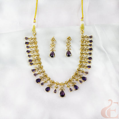 Jewelry set with necklace and earrings featuring purple stones on a white background