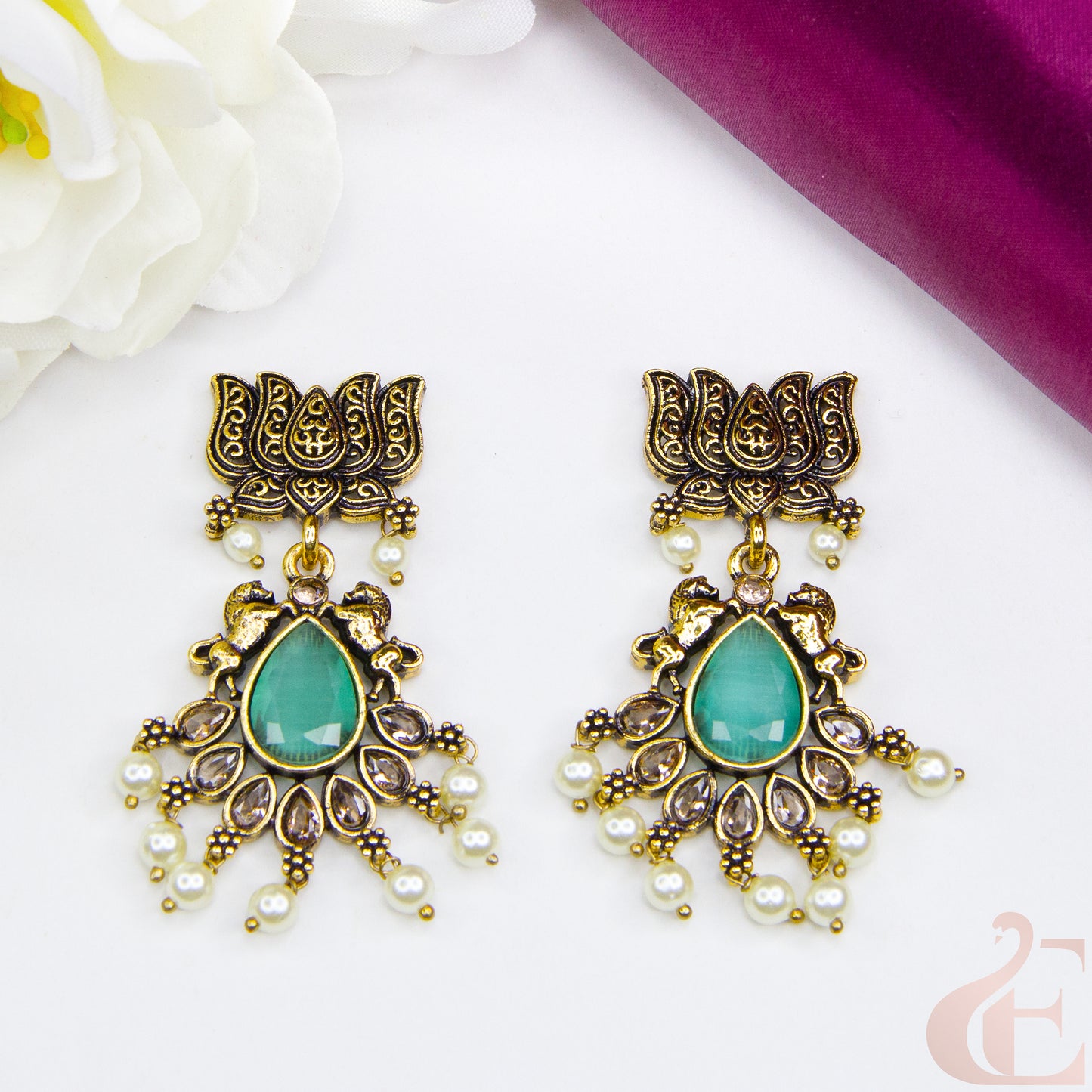 Top view of Mehndi finish lotus & horse designed earrings Pista Green Stone 