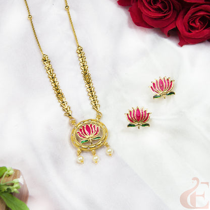 Gold necklace and earrings with pink floral designs on a white background