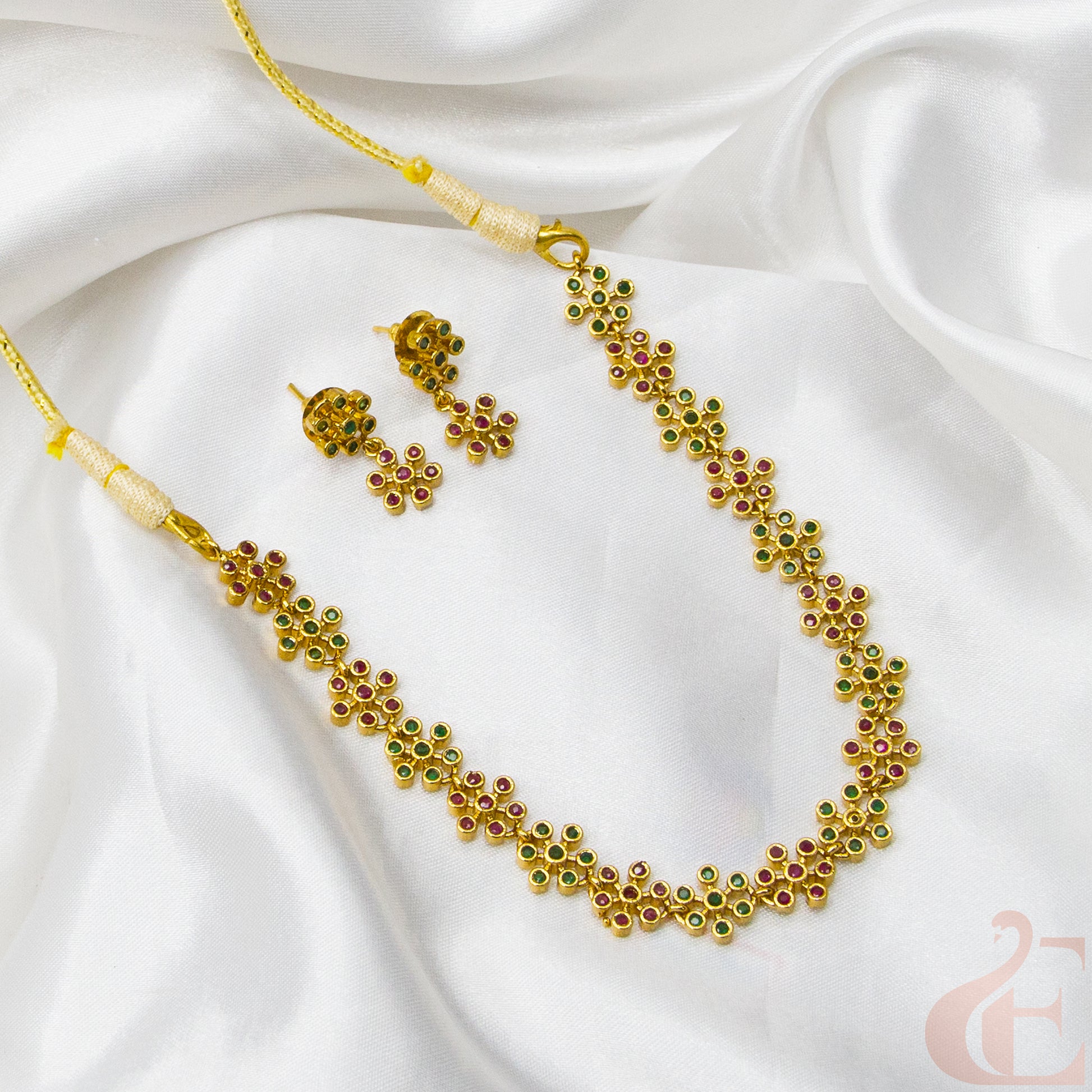 Top view of Premium AD Gold Finish Necklace & Earrings ruby green stones 