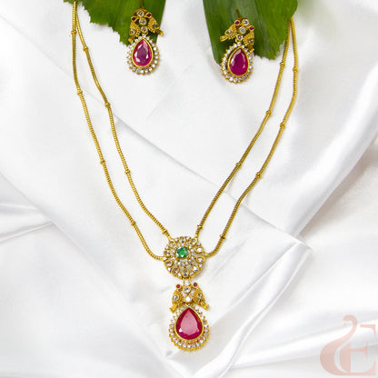 Top view of Premium AD stone Pendant Chain Neckpiece & Earrings , ruby green stones 