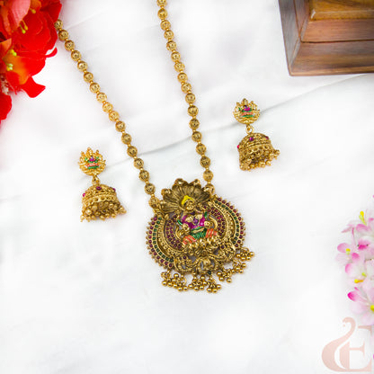 Gold necklace with pendant and earrings on a white background