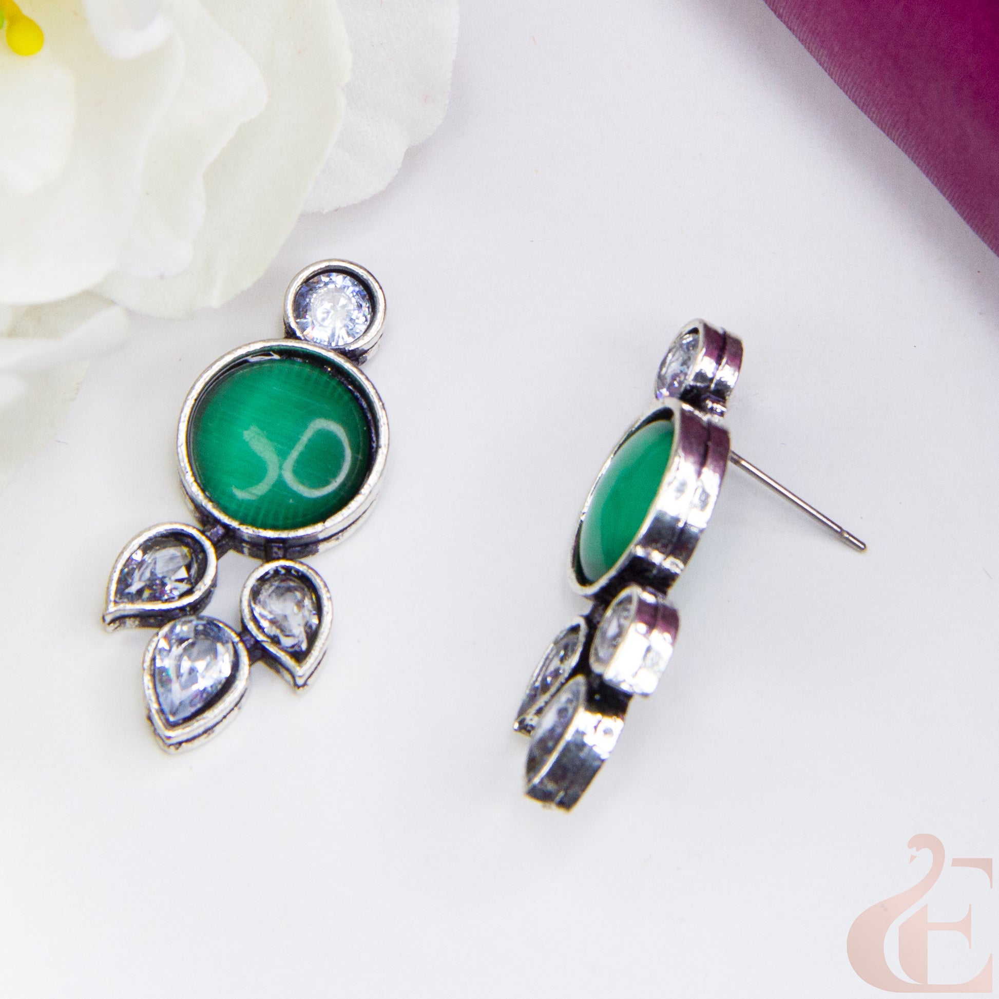 Top side angle view of Trendy Oxidized Silver Earring green and white Stone 
