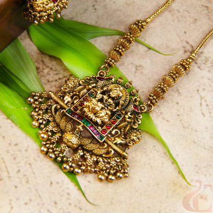 Gold necklace with intricate design on a green leaf